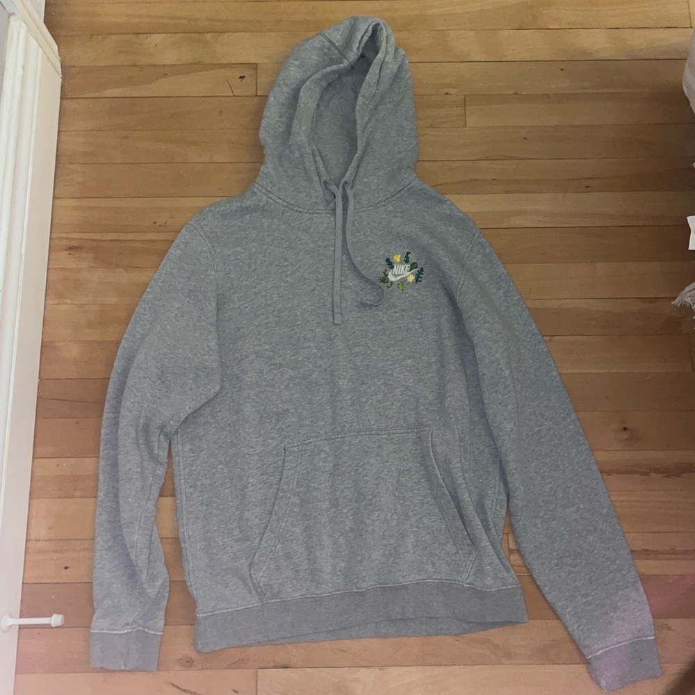 Medium grey Nike sweatshirt with flowers embroidered around the Nike logo.